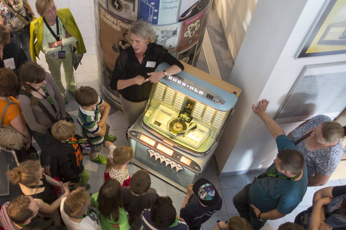 Besucher im Museum für Energiegeschichte(n) hören Schlager aus der Jukebox